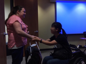  Shaking hands with a guide dog user at Mid-Atlantic ADA Center 